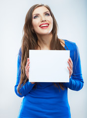 Teenager girl hold white blank paper. Young smiling woman show