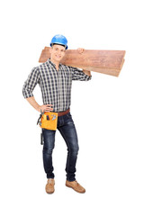 Construction worker holding a couple of planks