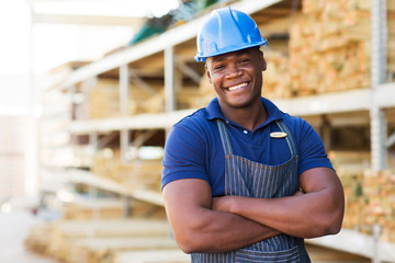 african male warehouse worker with arms crossed