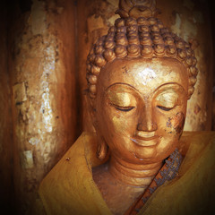 buddha statue sculpture with golden face in temple