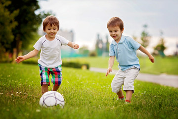 Two cute little boys, playing football © Tomsickova