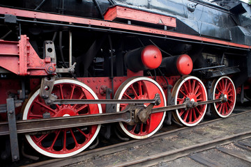 Fototapeta na wymiar Red wheel on a steam train locomotive