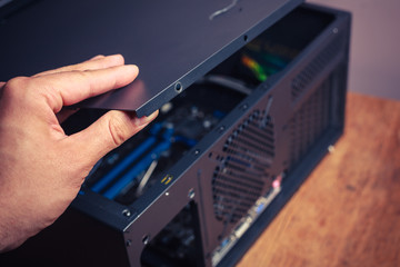 Hand opening a computer case