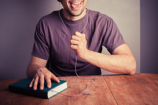Young man listening to audio book