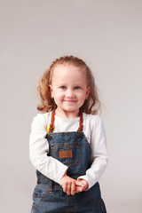 Pretty little girl posing in studio