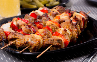 Grilled shashlik on the black plate,