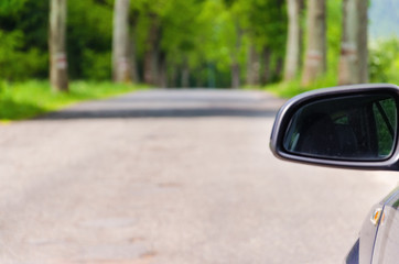 Car and rear view mirror on the road