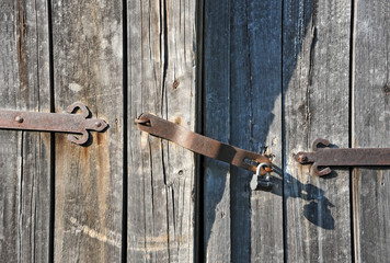 Rusty lock on old vintage rural wooden gate