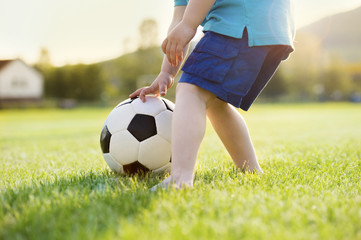 Little boy playing football