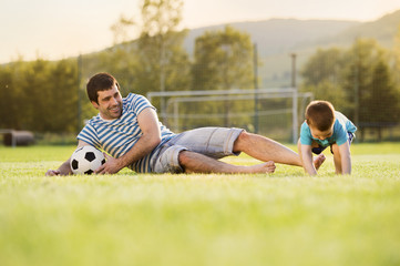 Naklejka premium Father and son playing football