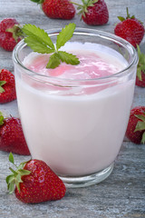 Fresh yogurt with strawberries on a rustic table