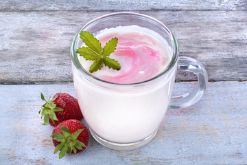 Fresh yogurt with strawberries on a rustic table