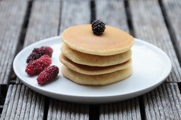 Stack of delicious pancakes with fresh fruits