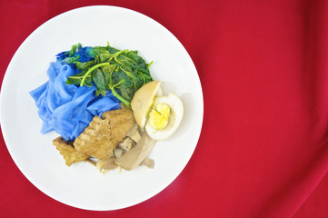 Blue rice noodle gravy vegetarian red background