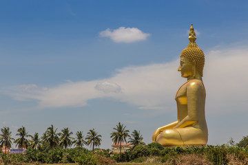 big  golden buddha statue sitting in temple