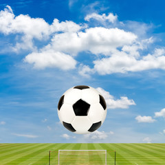 soccer ball with soccer field against  blue sky background