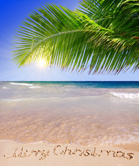 Merry Christmas written on tropical beach s. 