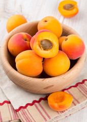 apricots in a bowl on wooden table