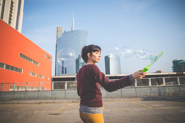 young beautiful hipster woman bubble blower