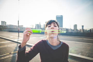 young beautiful hipster woman bubble blower