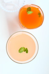 Grapefruit and carrot juice with ice and mint