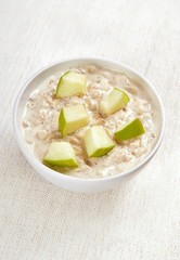 Oatmeal porridge with apple slices