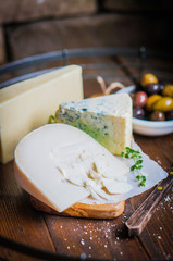 Assorted cheese on wooden background