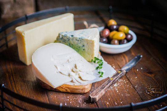 Assorted cheese on wooden background