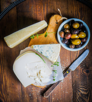 Assorted cheese on wooden background