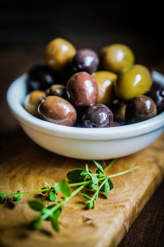 Olives on rustic wooden background