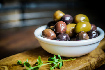 Olives on rustic wooden background