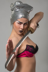 Beautiful girl in bra with katana