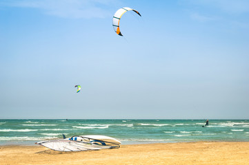 Kite surfing at tropical beach with windsurf board