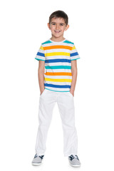 Young smiling boy in white trousers