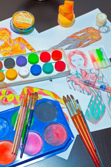 Naklejka premium brushes and colored paint artist on gray background