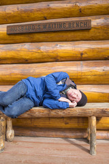 Husband Waiting for Wife on a Bench Outside of a Store