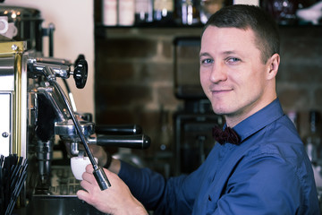 young man working as a bartender in a nightclub bar