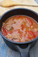 Stew with tomatoes, red bell pepper in sauce with spices in a s