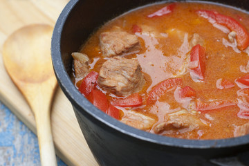 Stew with tomatoes, red bell pepper in sauce with spices in a s