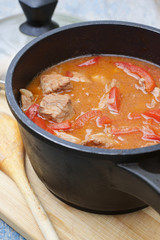 Stew with tomatoes, red bell pepper in sauce with spices in a s