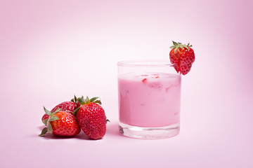 Strawberry smoothie on pink background