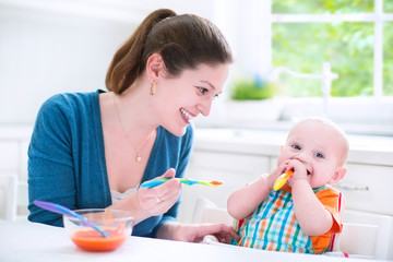 Baby boy eating his first solid food