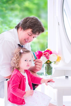 Father Brushing His Daughter Hair