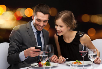 smiling couple eating main course at restaurant