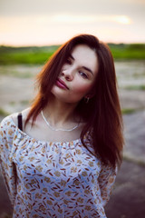 Fototapeta premium Beautiful girl outdoor in the park looking at you