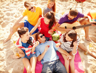 group of friends having fun on the beach