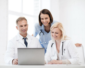 group of doctors looking at tablet pc