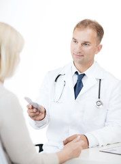 doctor giving tablets to patient in hospital