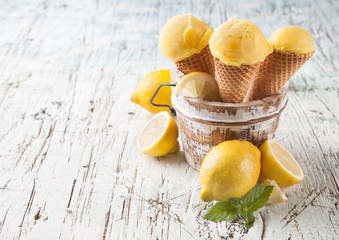 Fresh ice cream scoops in cones on wood