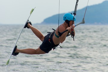 Close-up of female kite surfer while jumping